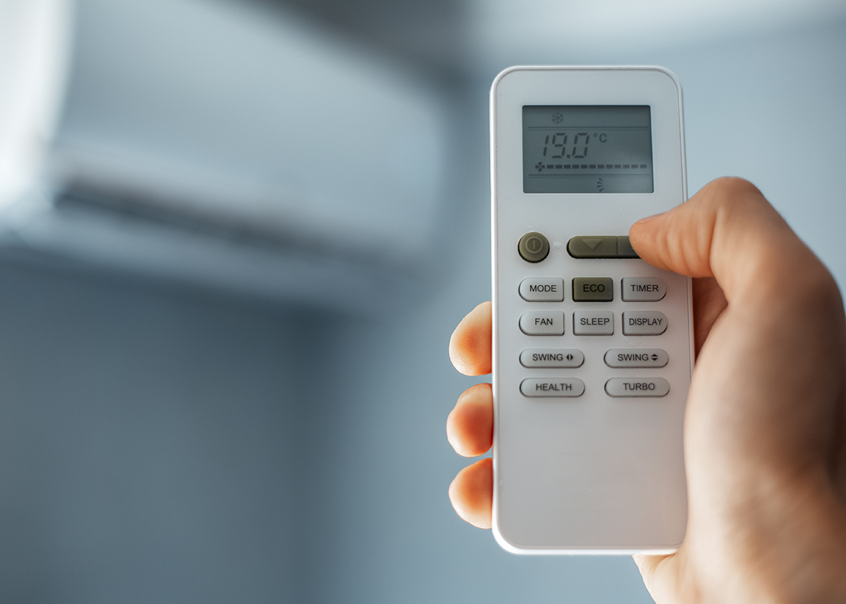 Main sur télécommande de clim